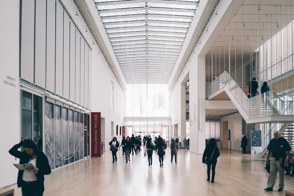 Spacious art gallery lobby with visitors in a modern architectural setting.